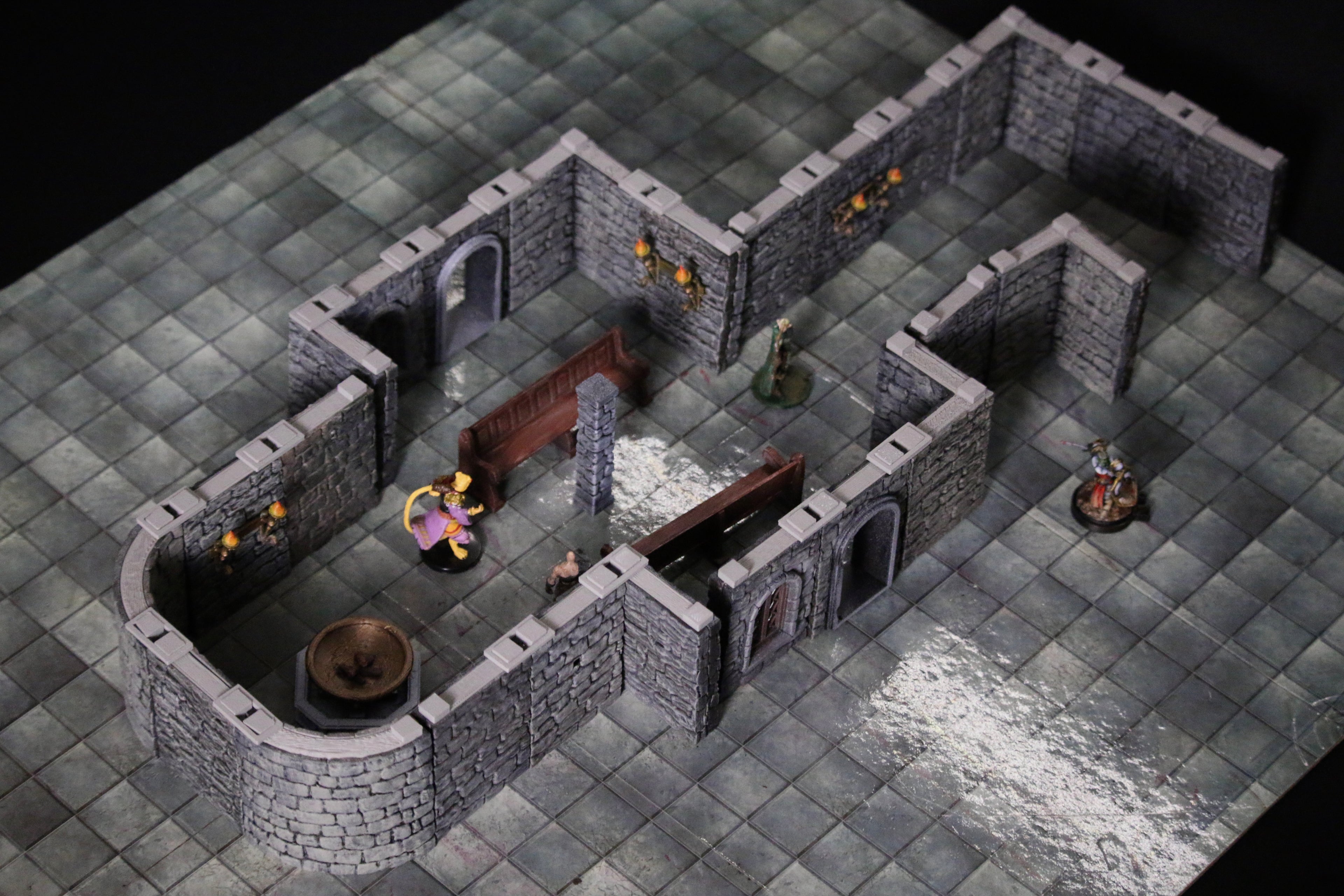 Isometric view of a dungeon layout with Omega Terrain stone walls on a flat grid floor designed for dry erase markers.